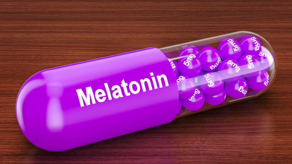 Egy lila melatonin kapszula, benne 5 mg-os golyók találhatók, fa háttér előtt.